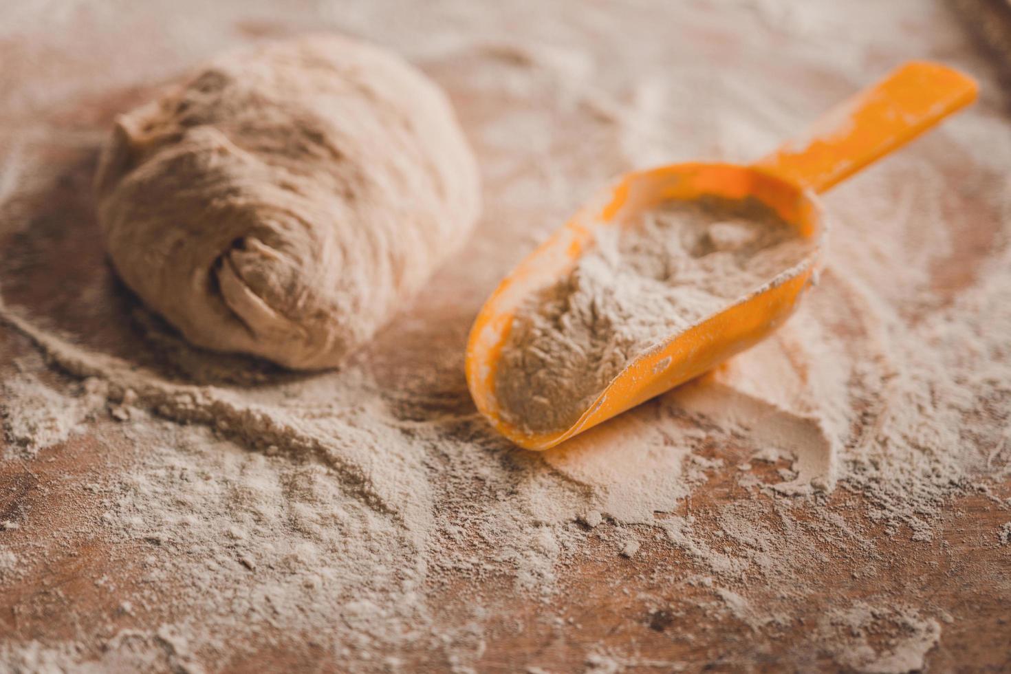 Dough and flour with dumplings on a wooden board photo