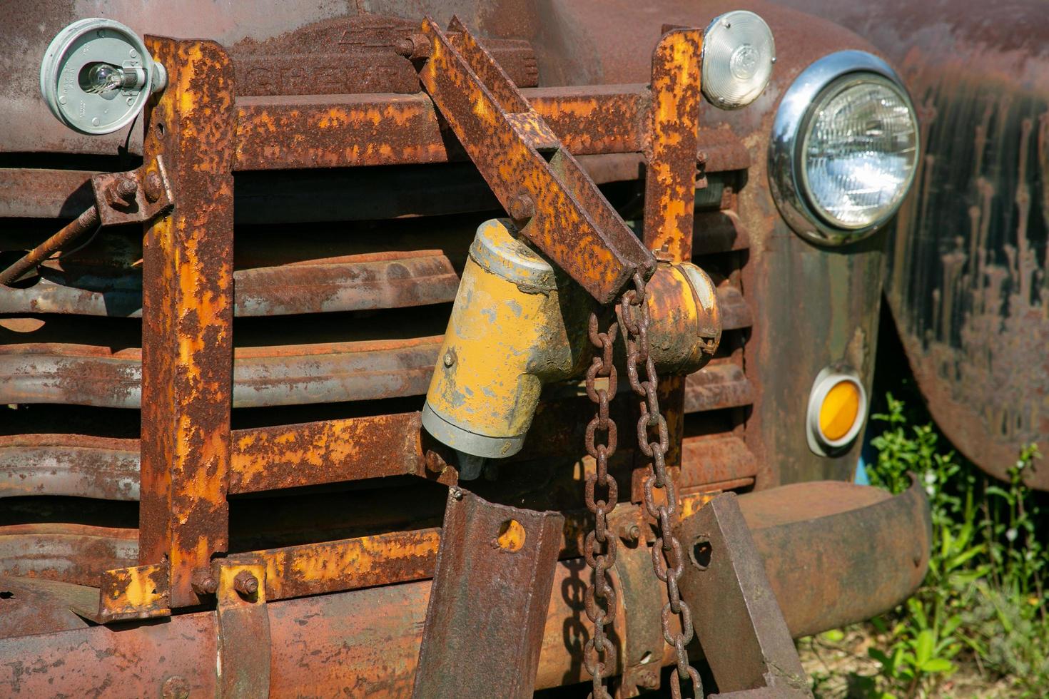 Snow plow lift of an old rusty truck photo