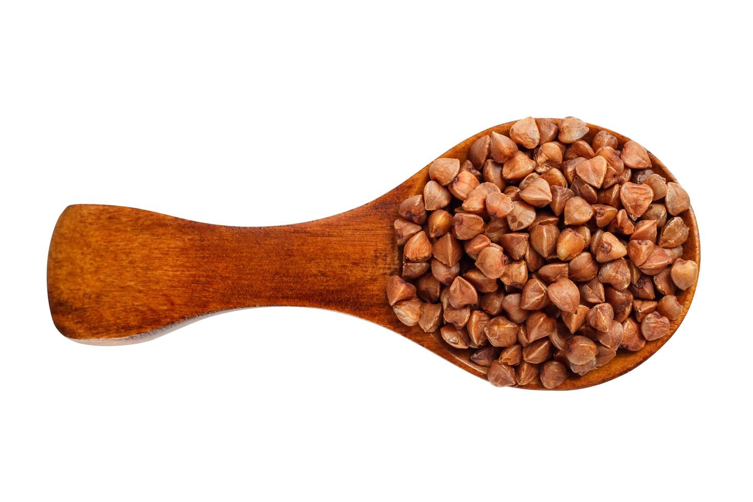 Buckwheat in a wooden spoon on a white background photo