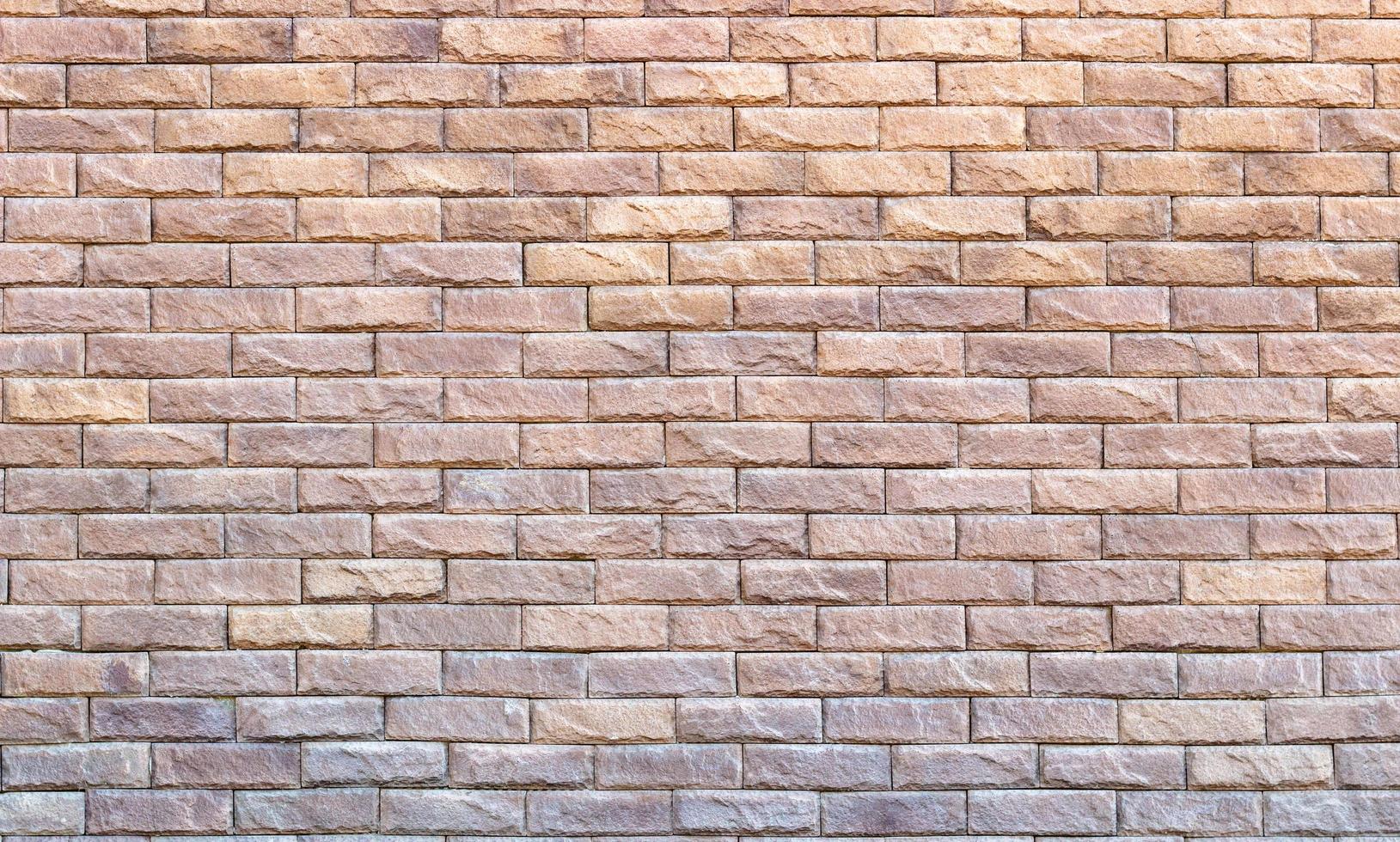 Background of yellow facing bricks. Bricks relief close up photo