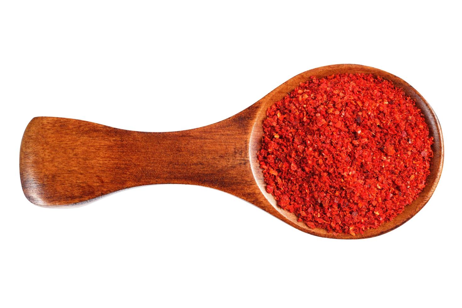 Red ground pepper in a wooden spoon photo