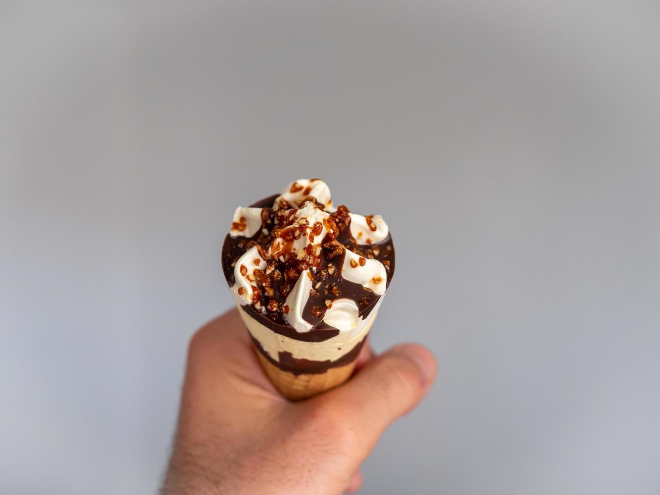 Chocolate ice cream with nuts in a waffle, photo close up details