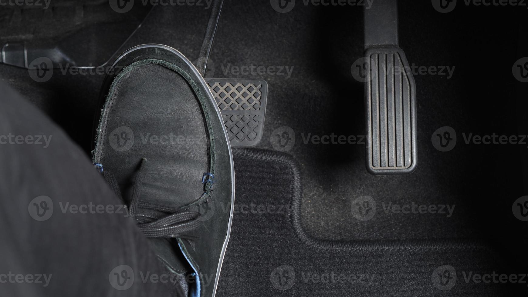 Man foot and accelerator and brake pedal inside the car photo