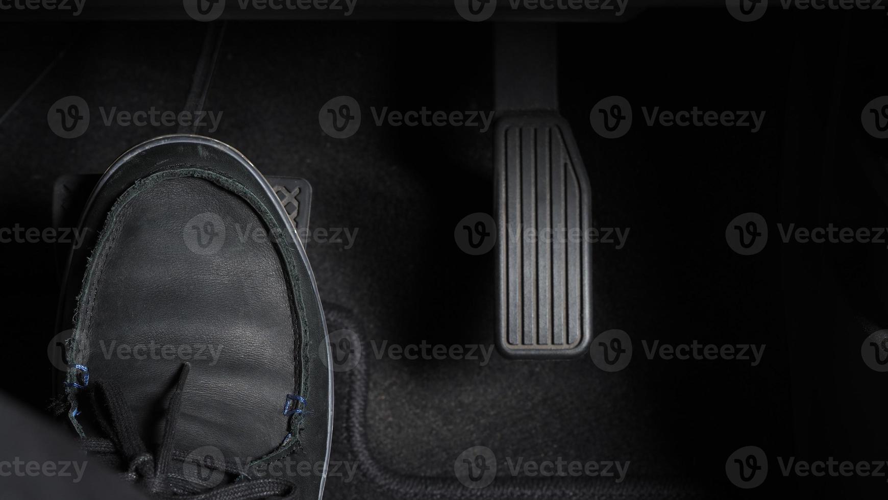 Man foot and accelerator and brake pedal inside the car photo