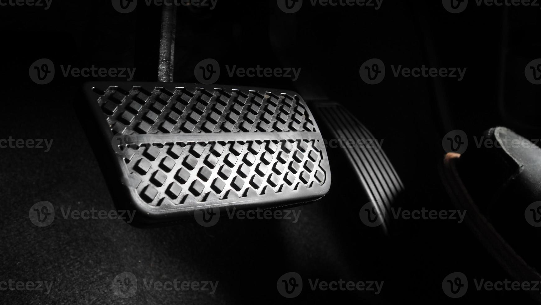 Man foot and accelerator and brake pedal inside the car photo