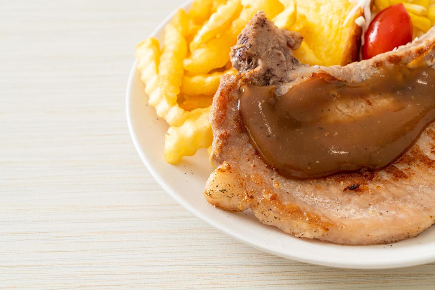 Pork chop steak with chips and mini salad photo