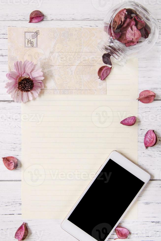 Paper with flowers and phone photo