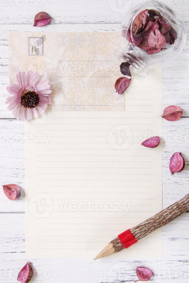 Paper with flower and pencil photo