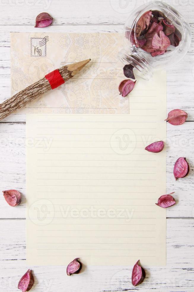 Paper with petals and pencil photo