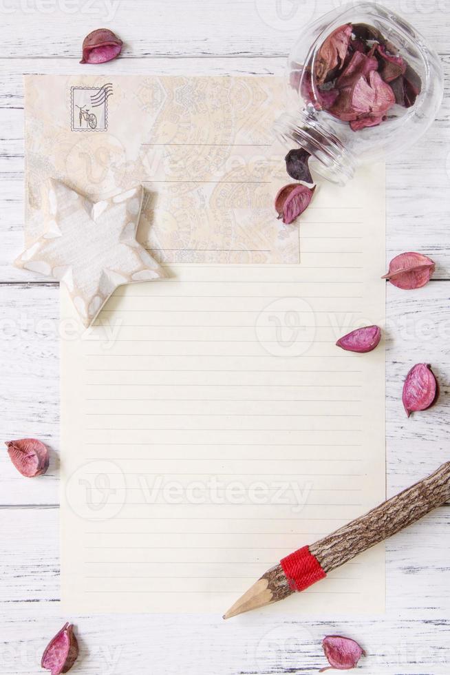 Paper with petals, pencil and star photo