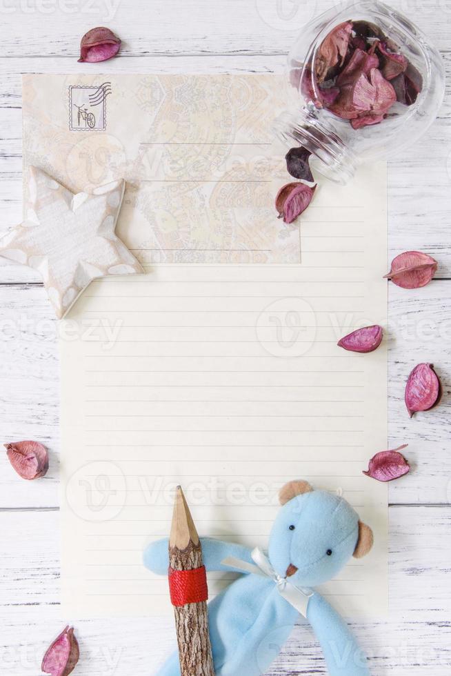 Paper with petals, pencil, toy and star photo