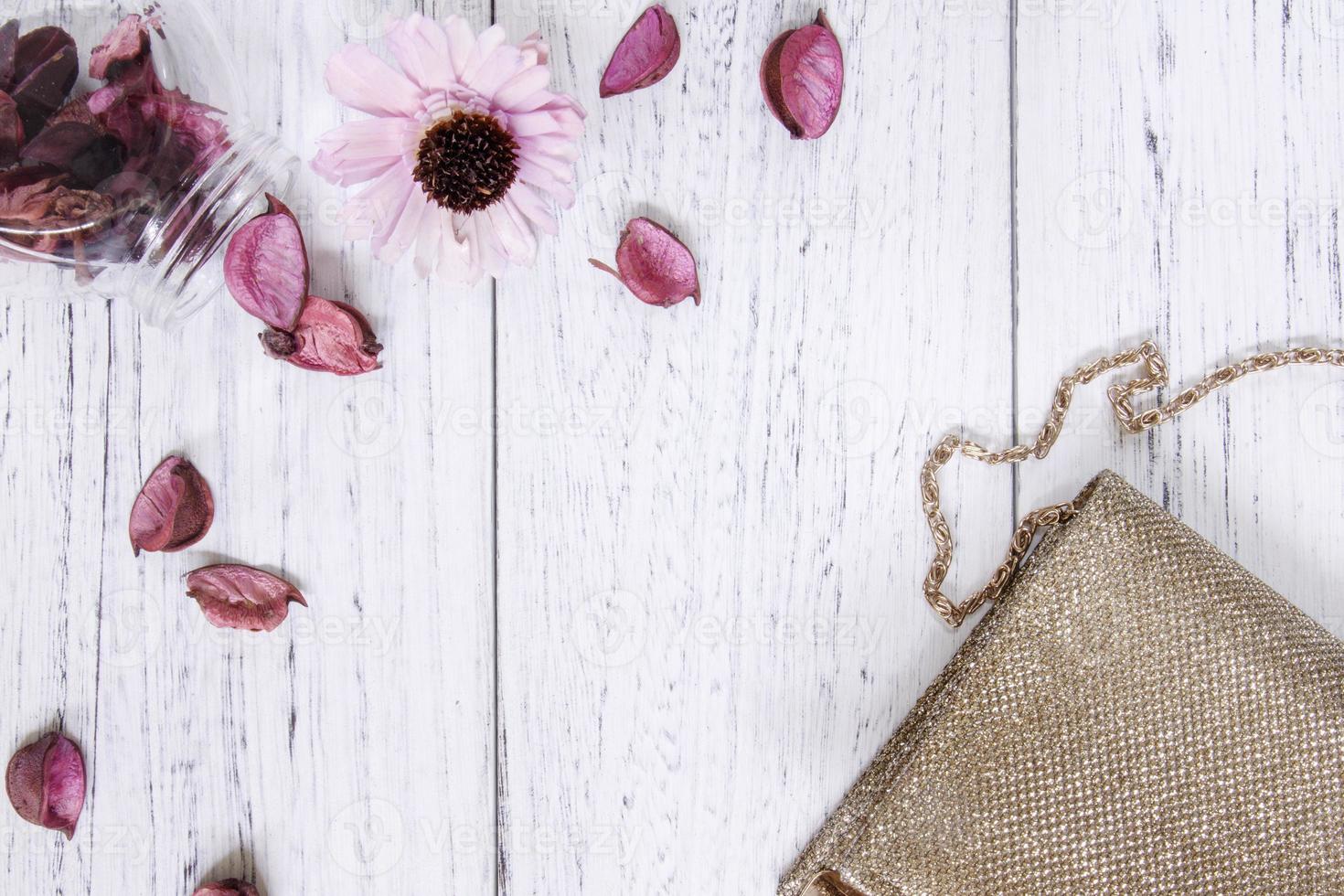 Purse and flower on white wood photo