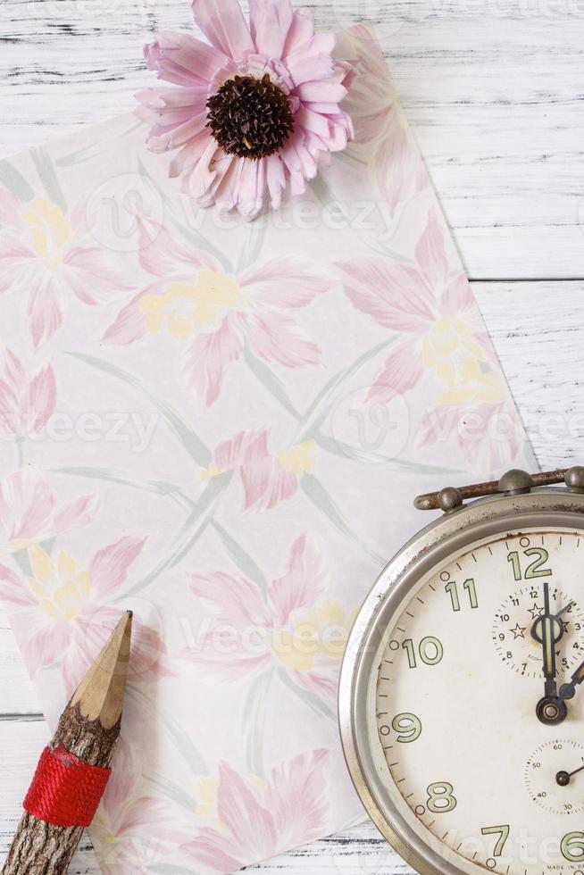 Floral paper with pencil, flower and clock photo