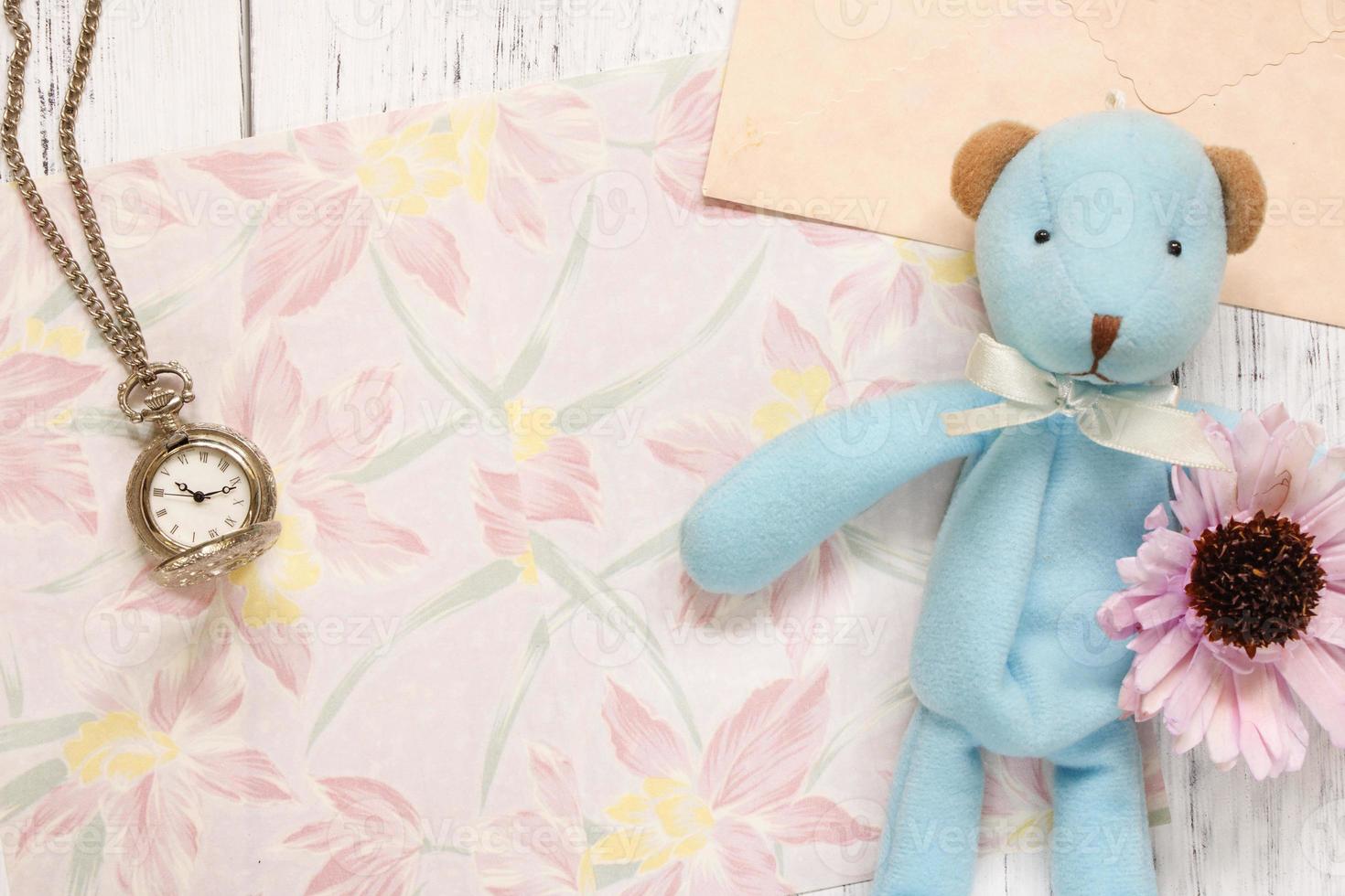 Floral paper with a watch, flower, and toy photo