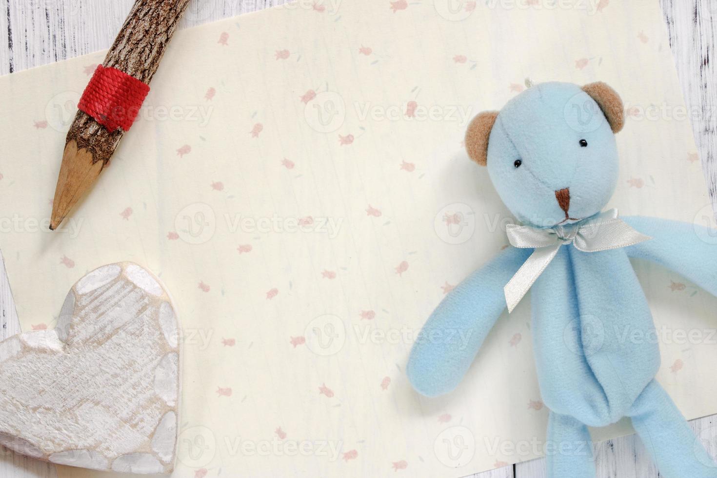 Paper with heart, pencil and bear photo