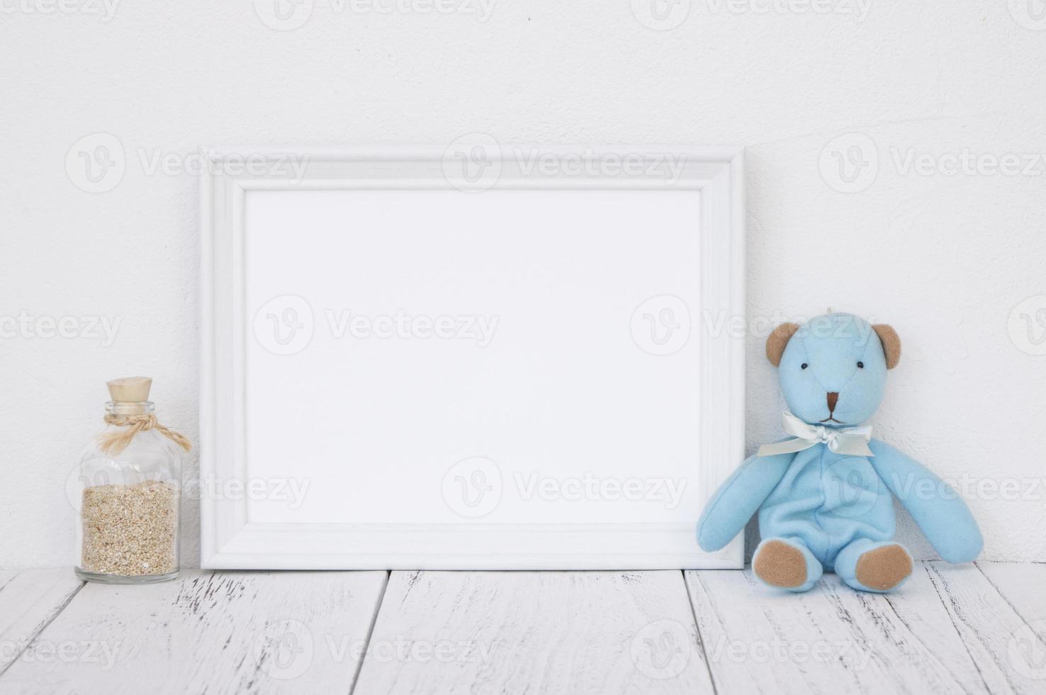 White frame with bottle and bear photo