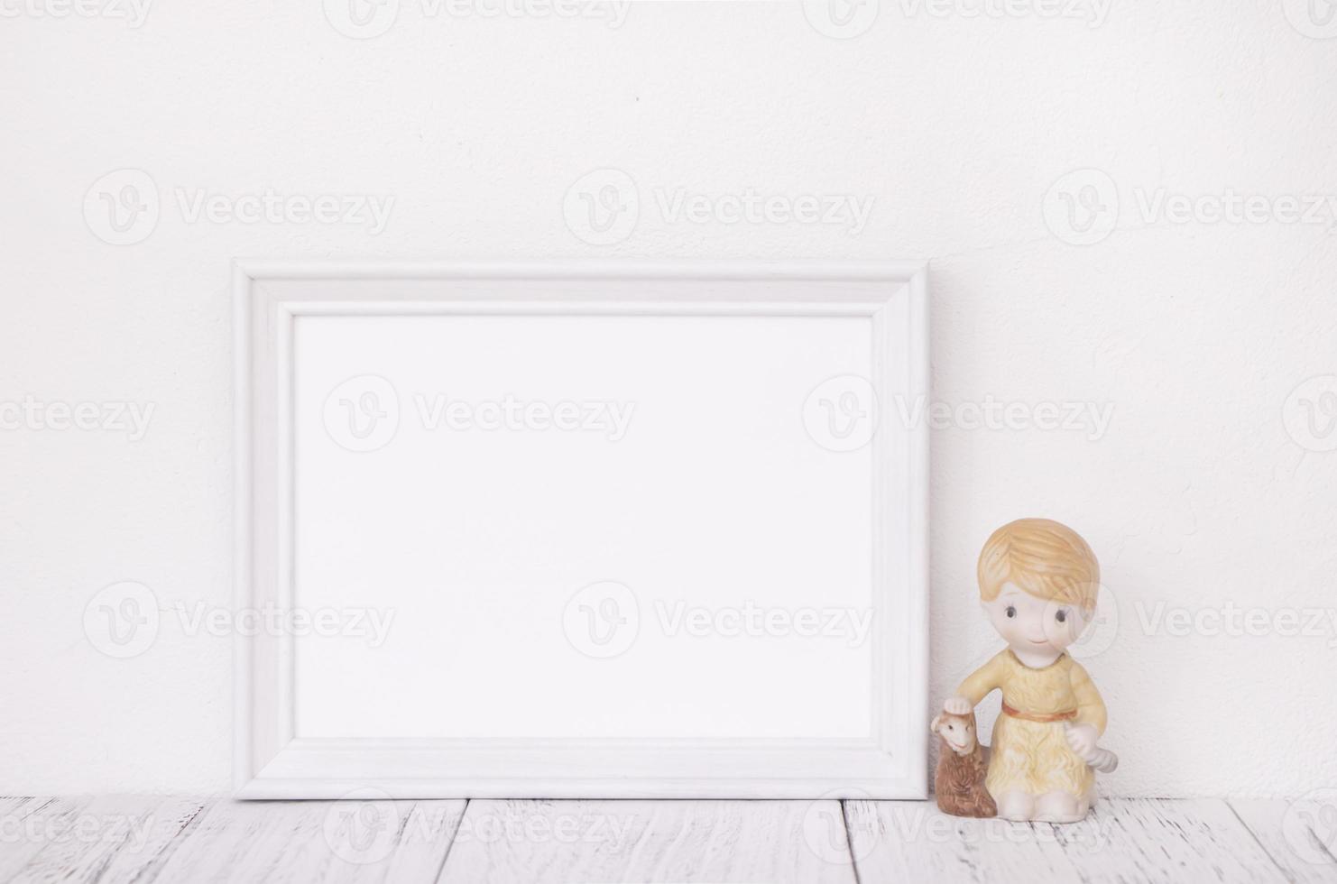 White frame with ceramic doll photo