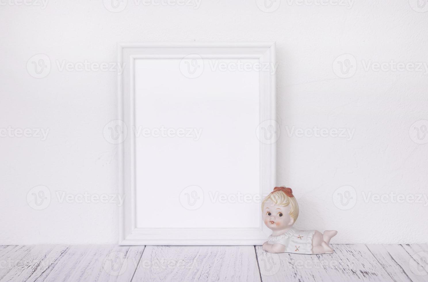 White frame with ceramic figurine photo