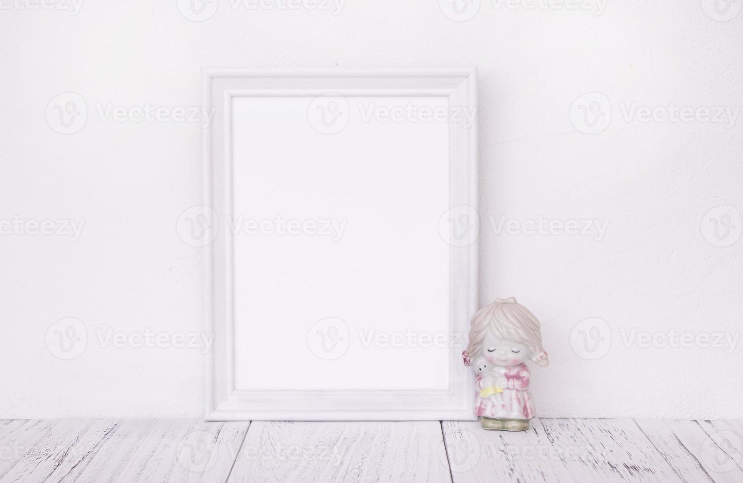 White frame with ceramic figurine photo