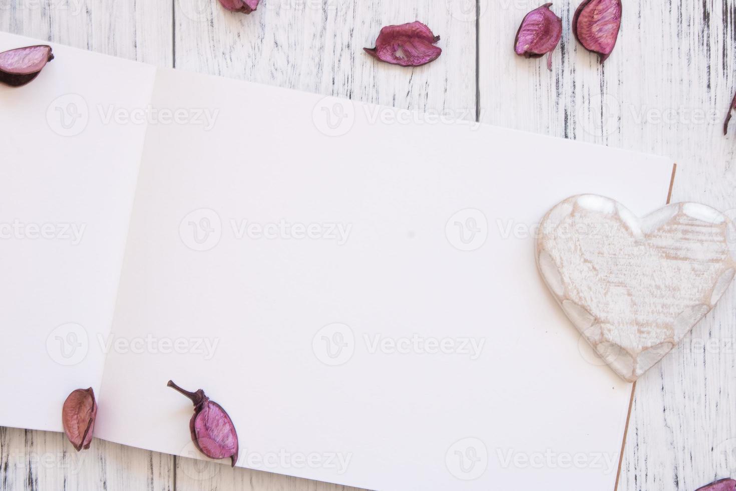 Paper with petals and heart photo