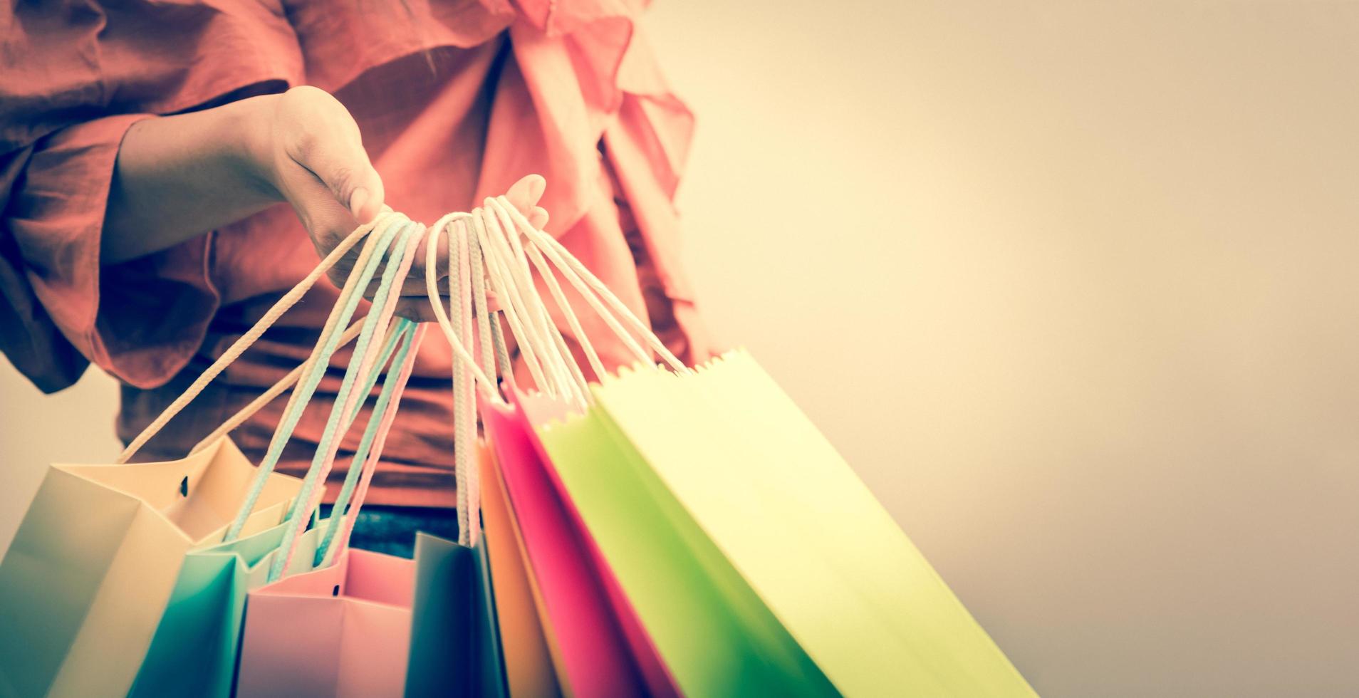 Closeup of woman holding color paper shopping bag photo