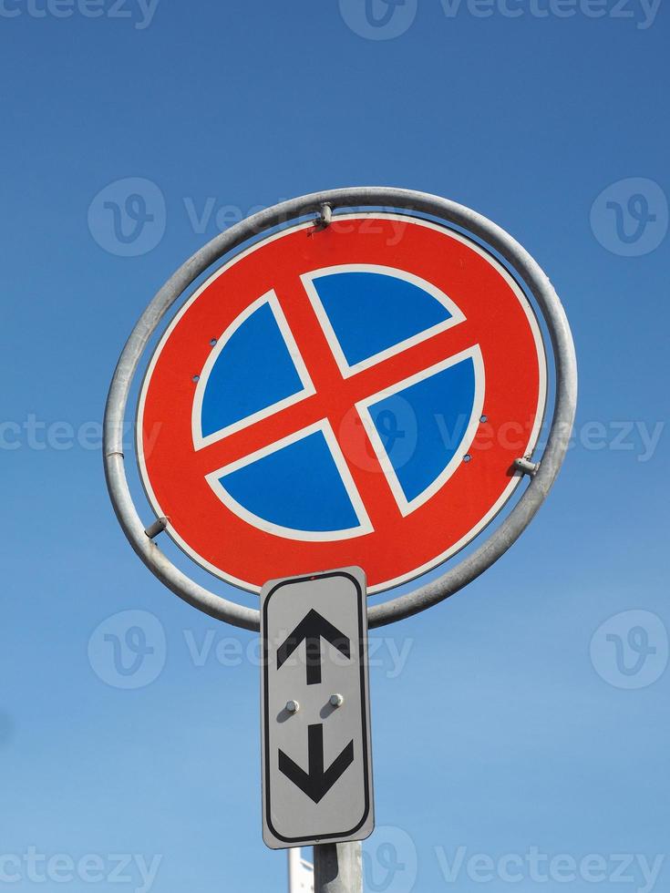 No parking and no stopping sign over blue sky photo