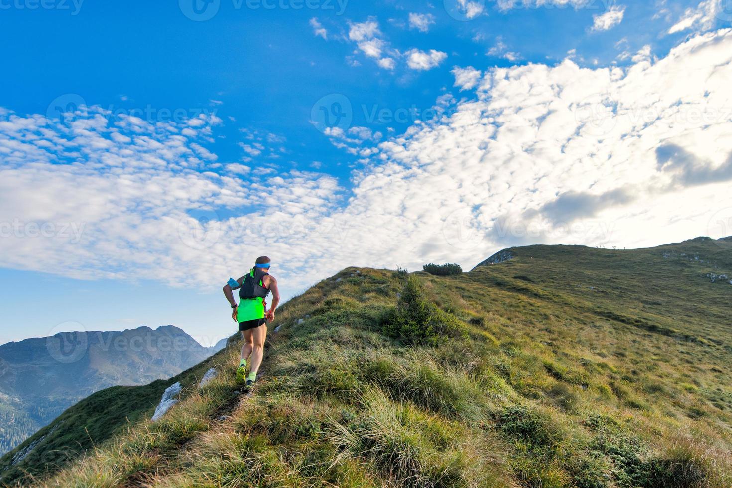 Sporty mountain man rides in trail during endurance race photo