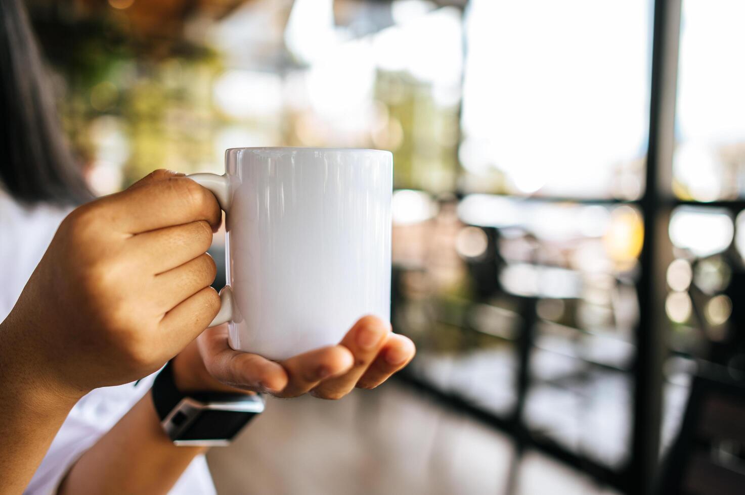 white cup on hand in relax time photo