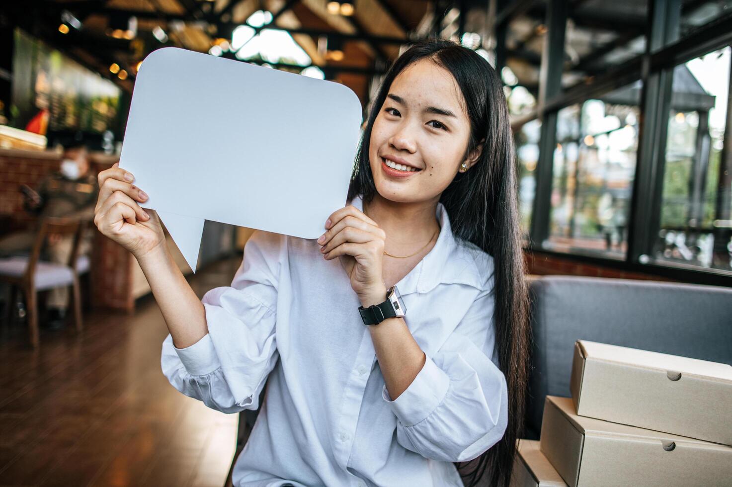 woman holding speech bubble rectangle with conners rounded photo