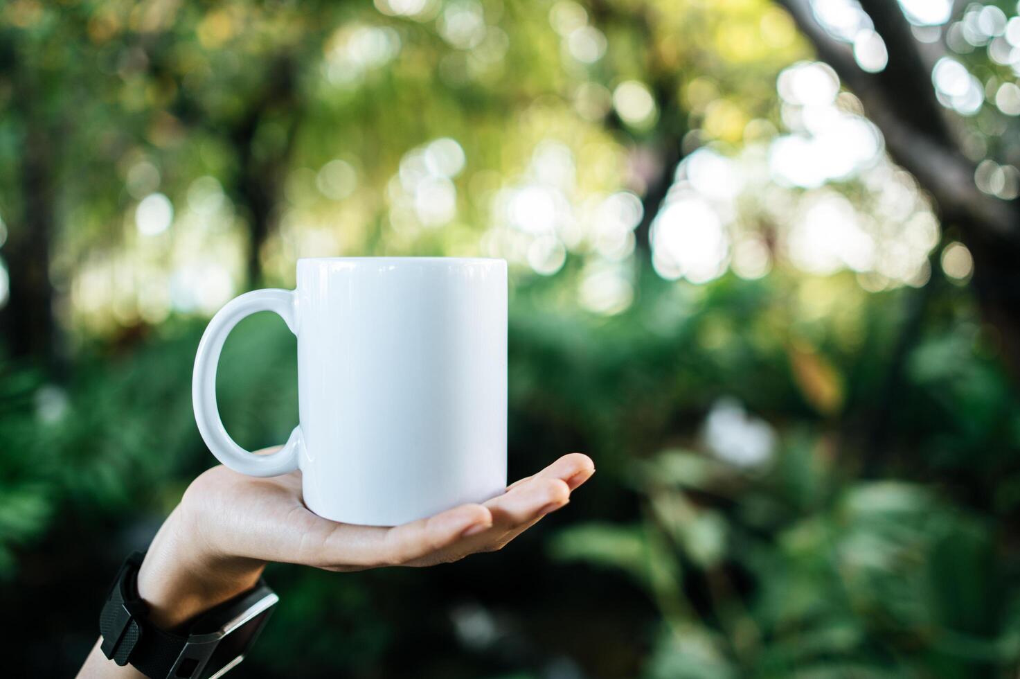 white cup on hand in relax time photo