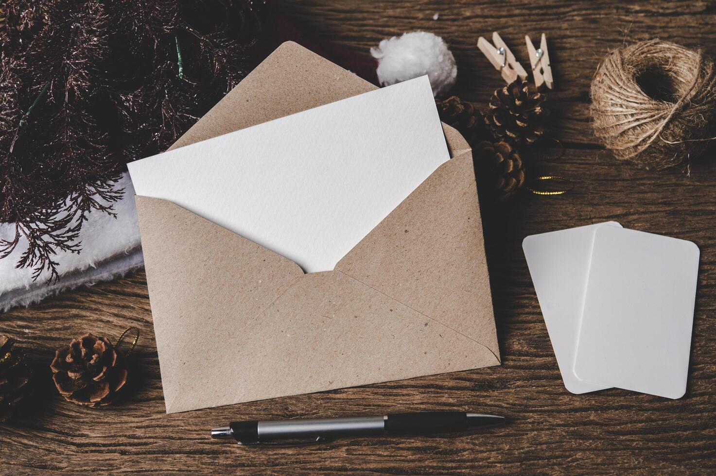 Envelope, blank card and a pen is placed on wood. photo