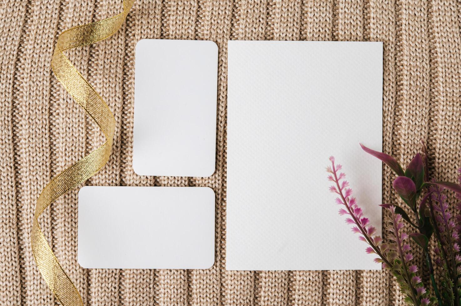 tres tarjetas en blanco, cinta dorada y una hoja en un suéter foto