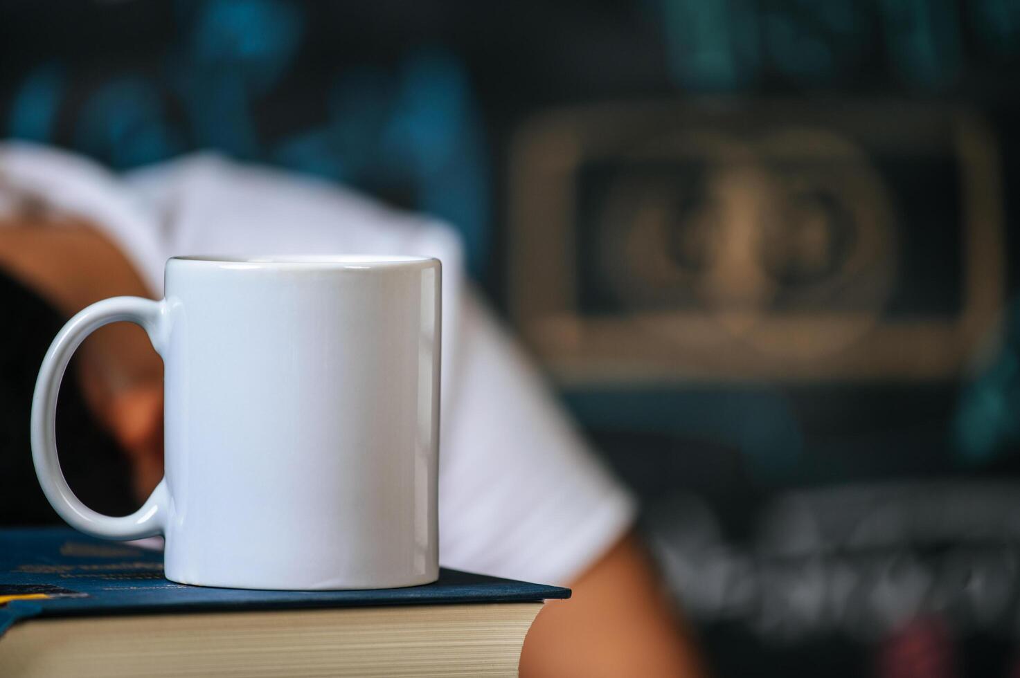 cup on the books in classroom photo