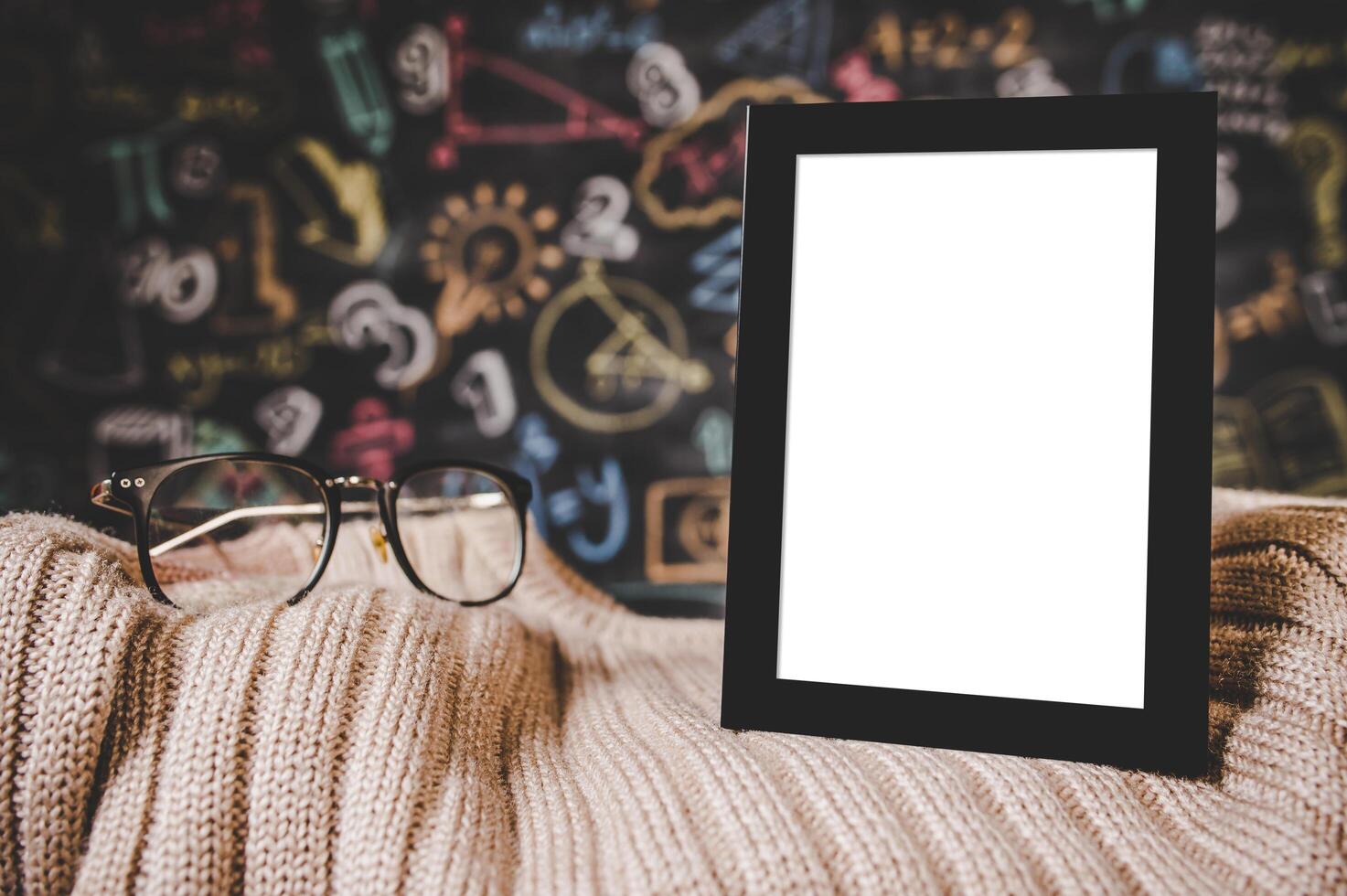 black photo frame and glasses on the sweater in classroom