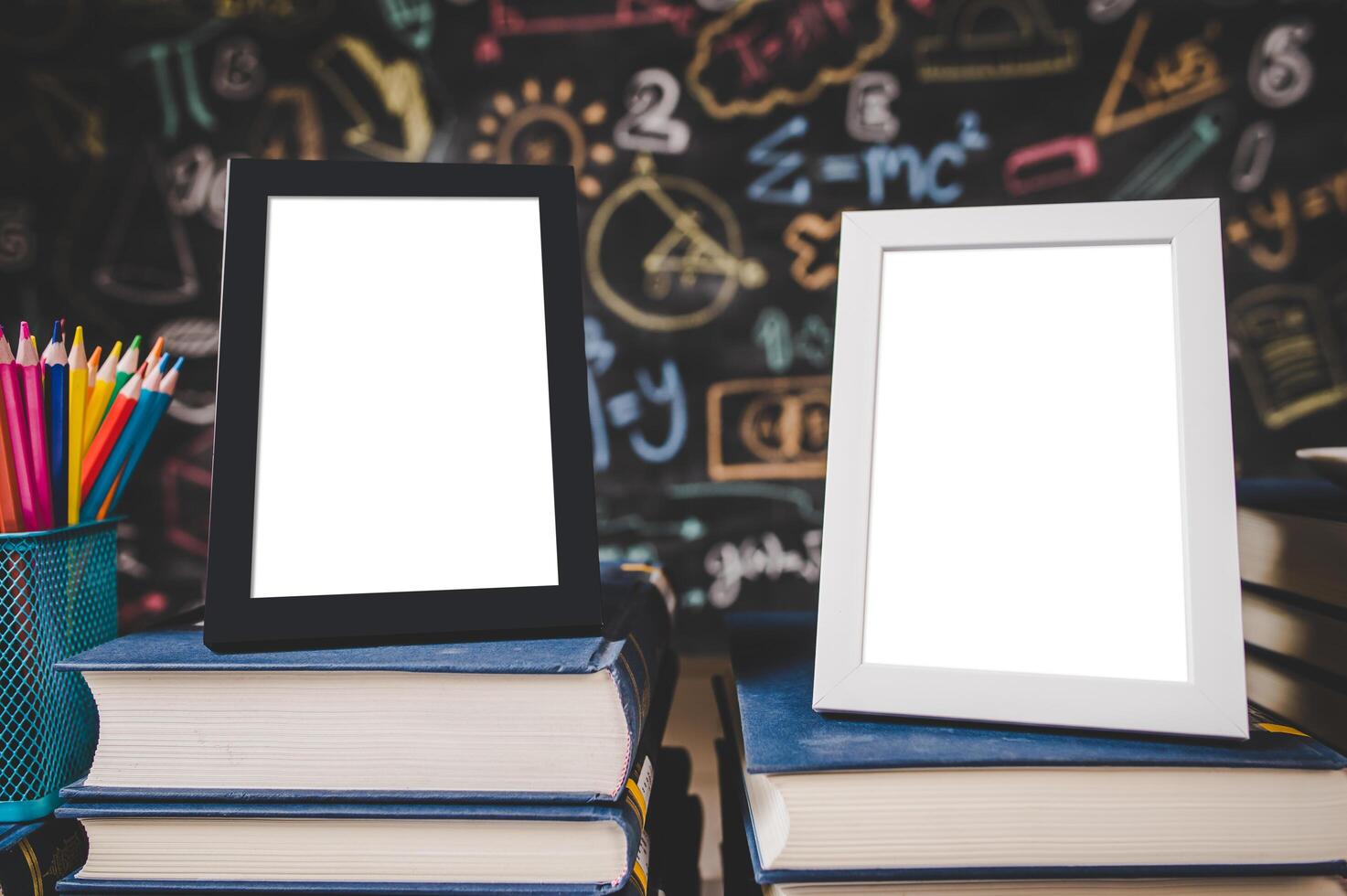 black photo frame and white photo frame on books