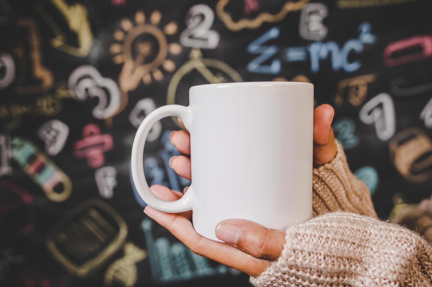 hand holding the cup in the classroom photo