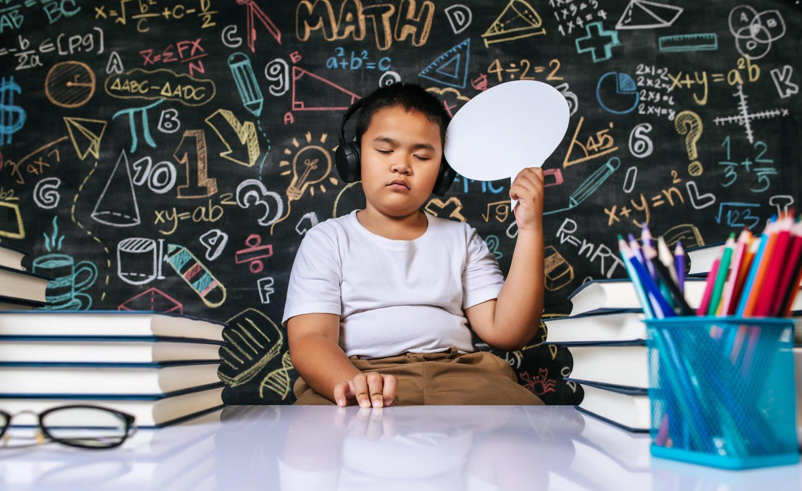 Child acting with speech bubble in the classroom photo