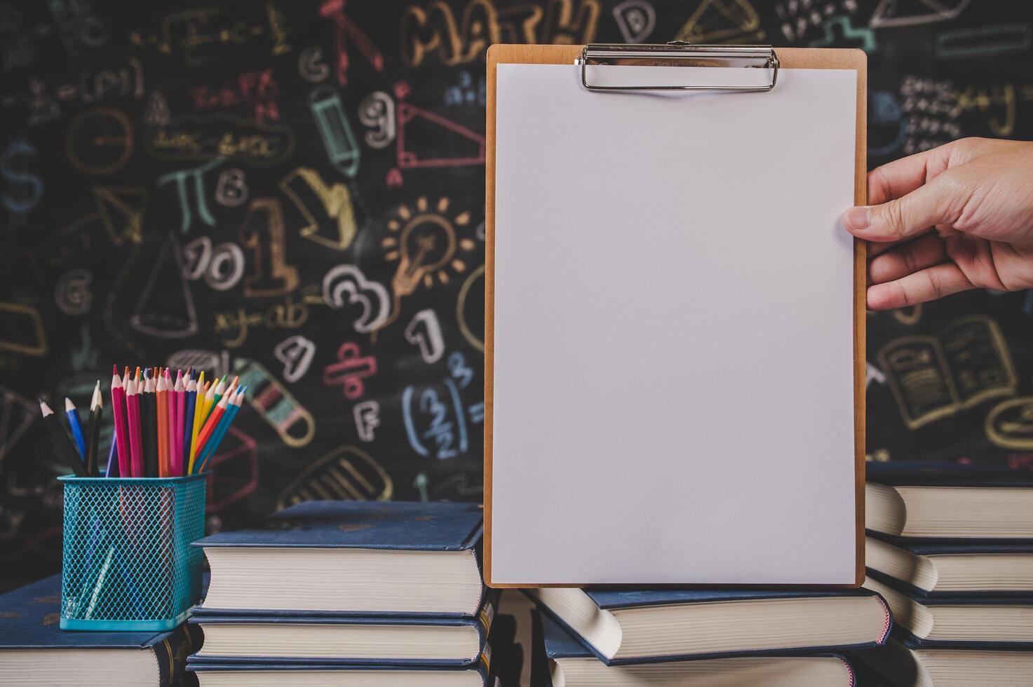 hand holding clipboard in class room photo