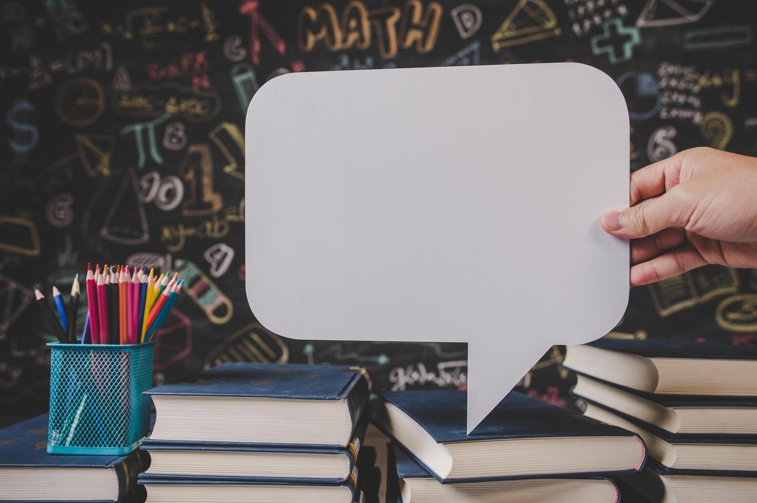 hand holding speech bubble in class room photo