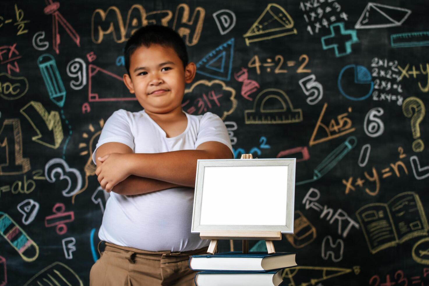 Child standing and acting in the classroom photo