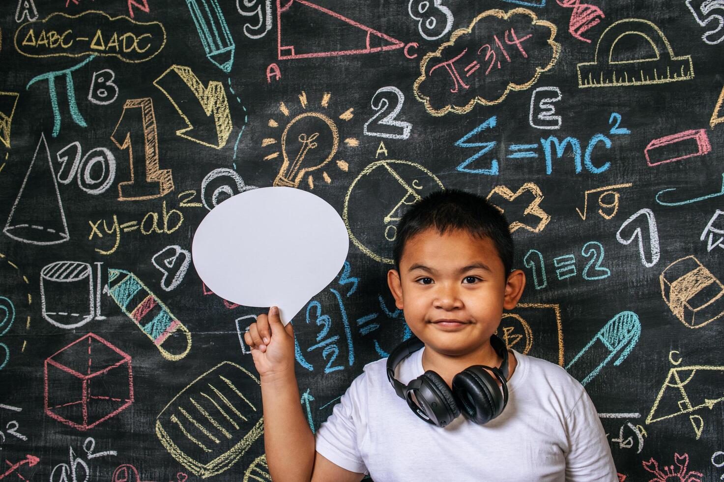 Child acting with speech bubble in the classroom photo