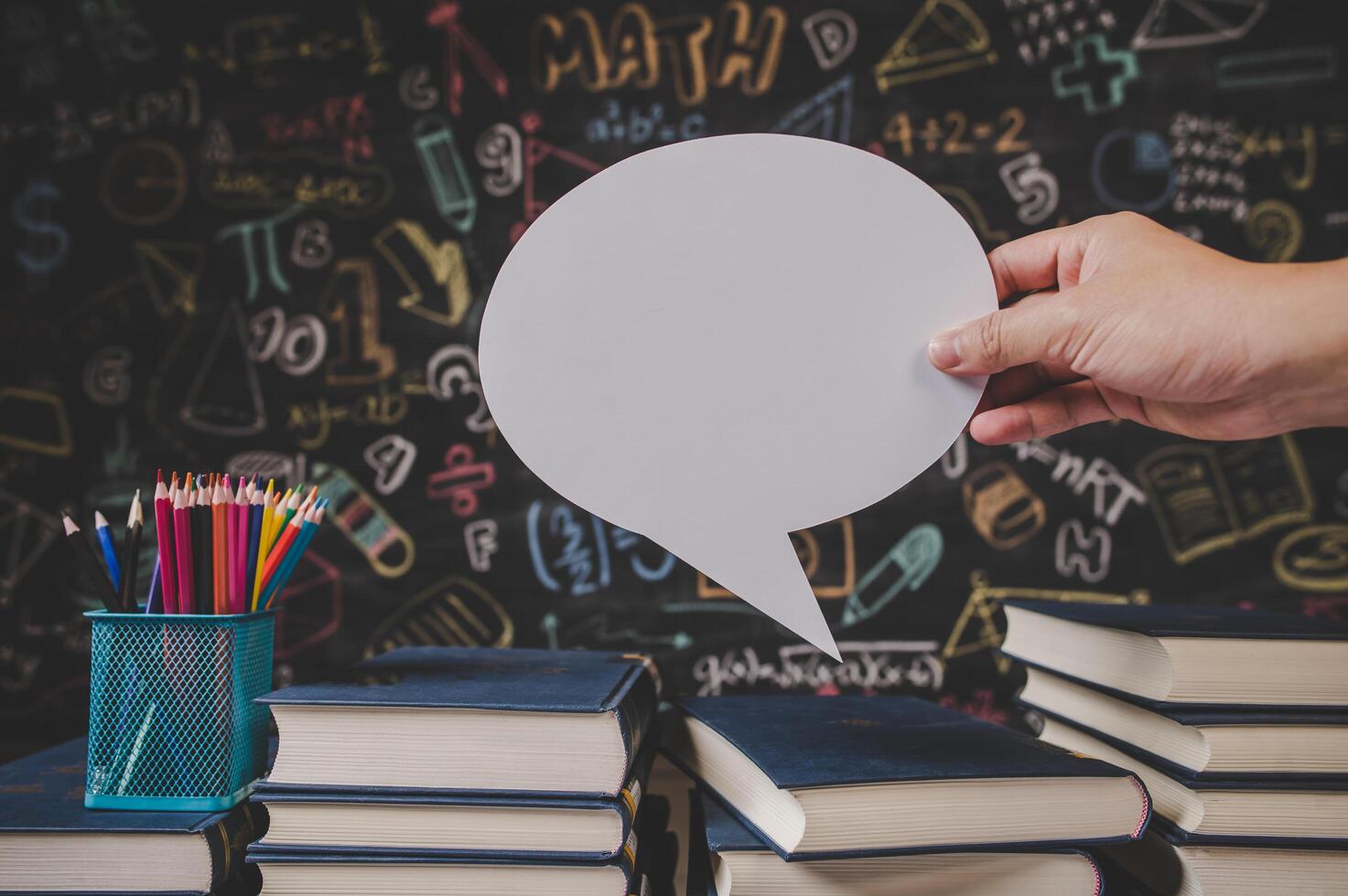 hand holding speech bubble in class room photo