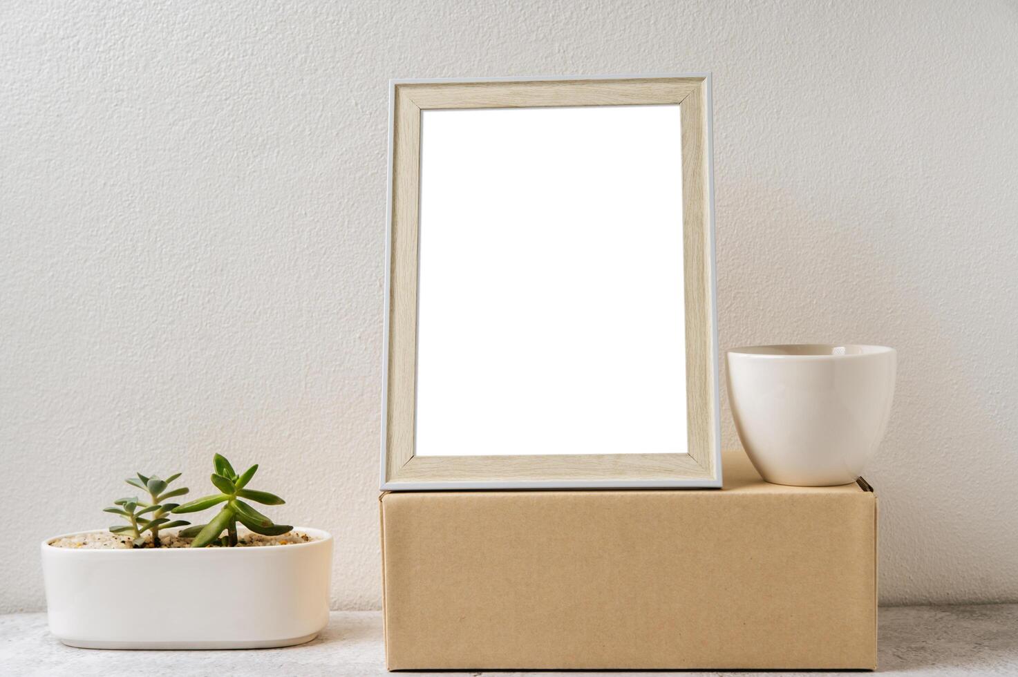 Standing picture frame with small potted plants photo