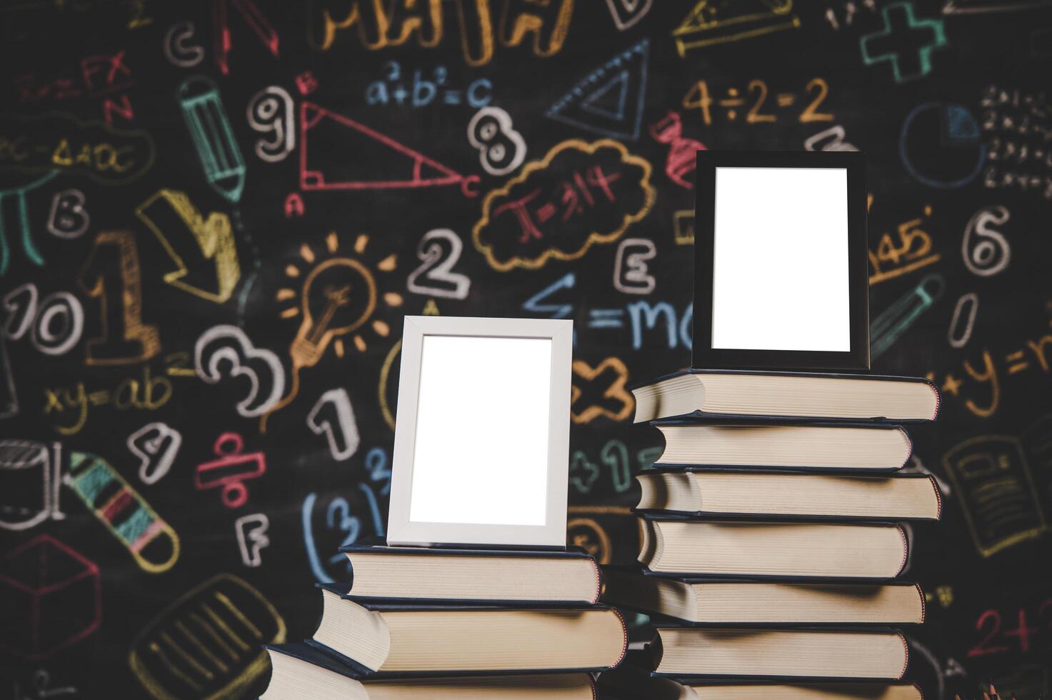 black photo frame and white photo frame on books in classroom