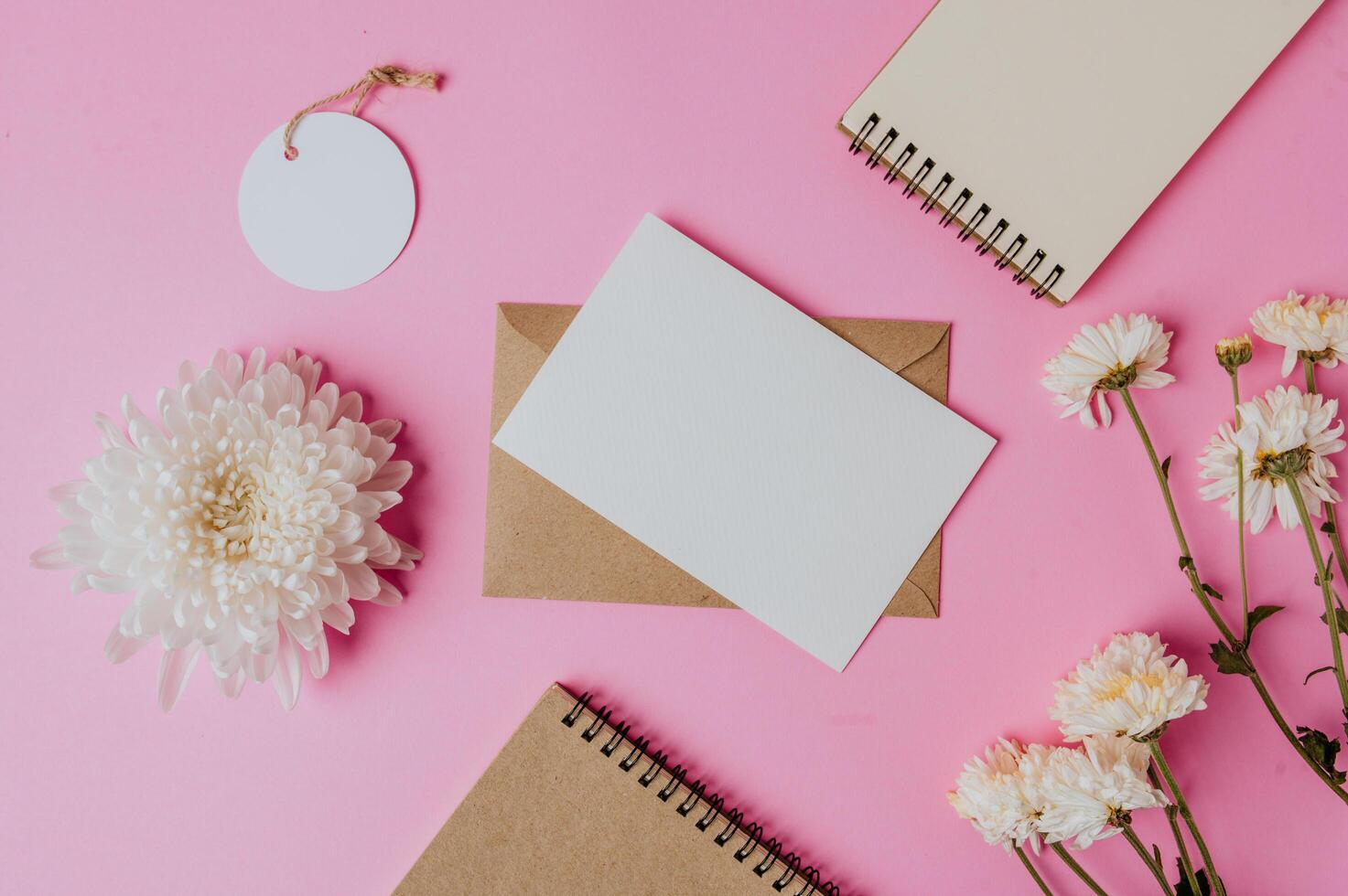 brown envelope, tag, notebook with blank card and flower photo