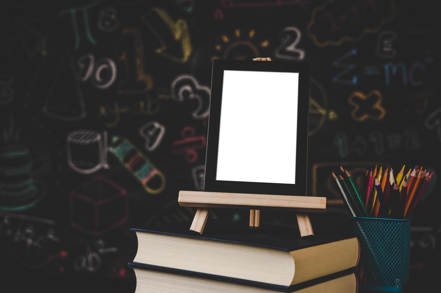 black photo frame on the stand on the books in classroom