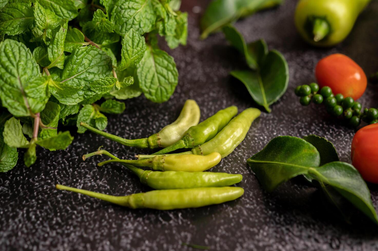 Chili, kaffir lime leaves, mint, tomato and fresh pepper photo