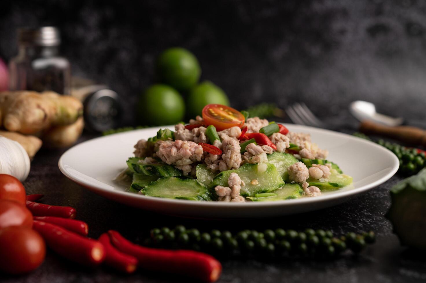 Stir fried zucchini with minced pork in white plate photo