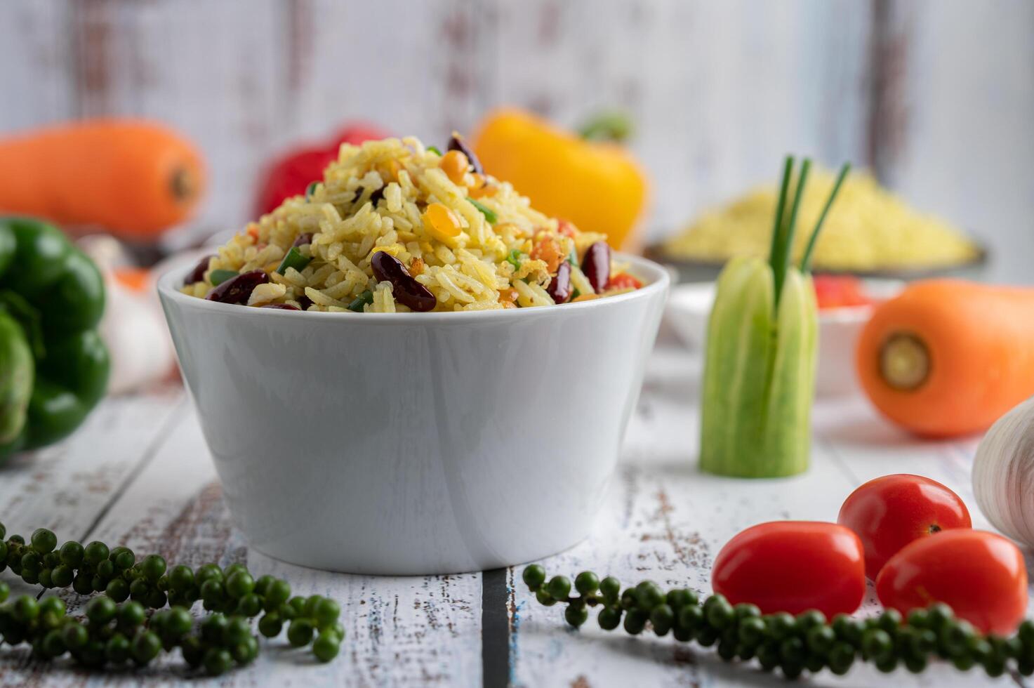 Mixed fried rice in a cup on a white wooden floor photo