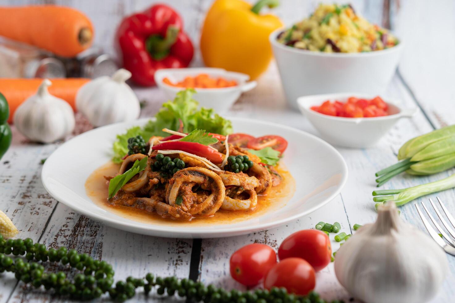 Stir-fried squid with curry paste in white plate. photo